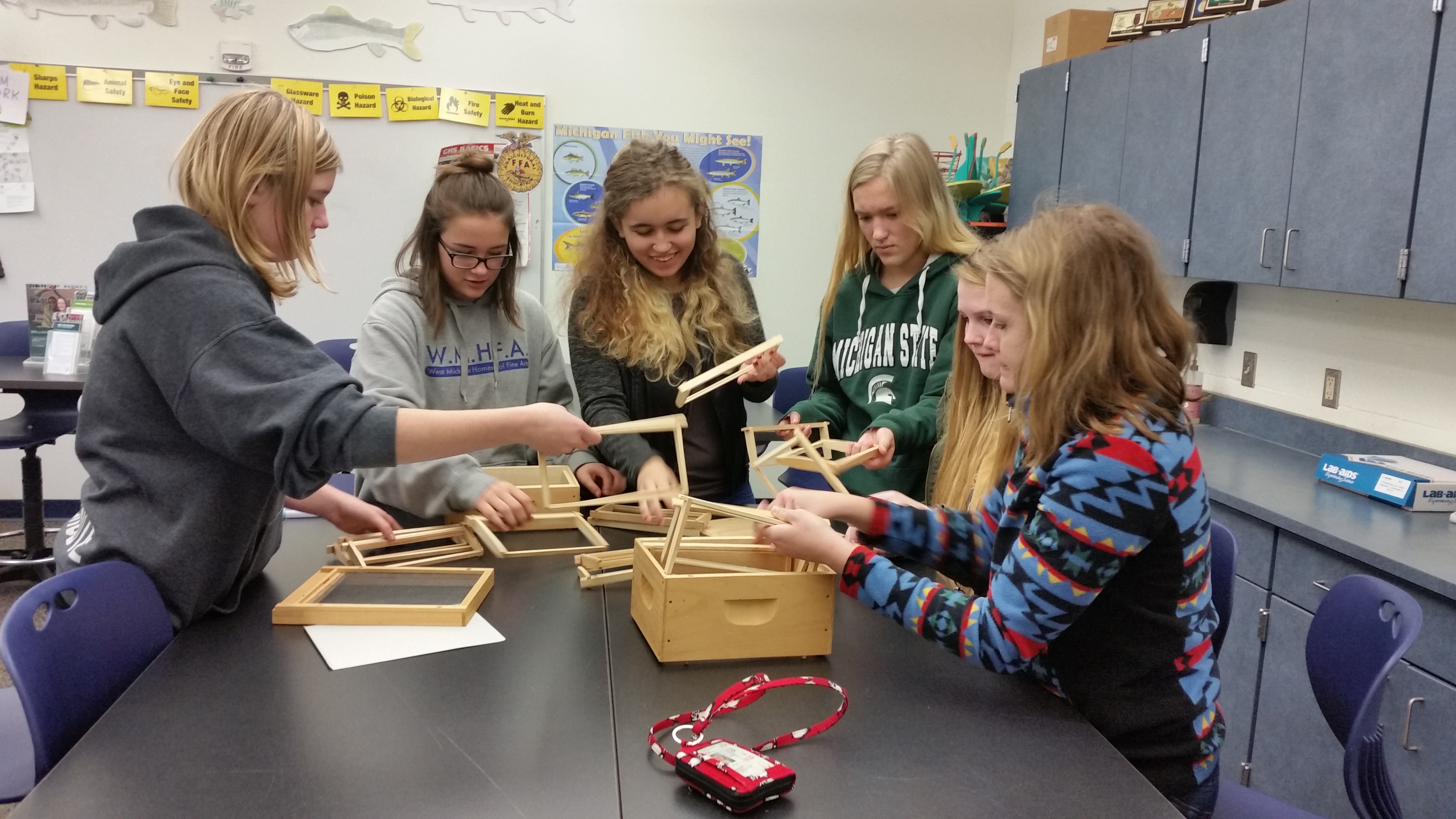 Students assembling model beehives at West Shore Community College